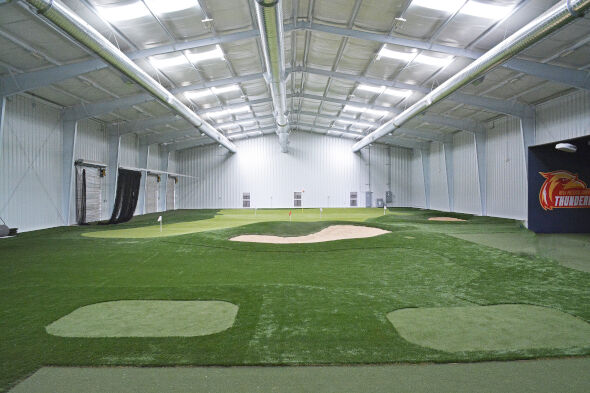 Oakley indoor putting facility with tee boxes